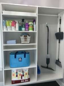 Cleaning area organized with cleaning agents in one area, and Aldi bag storage and tools in another.