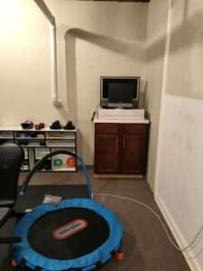Organized basement workout area.