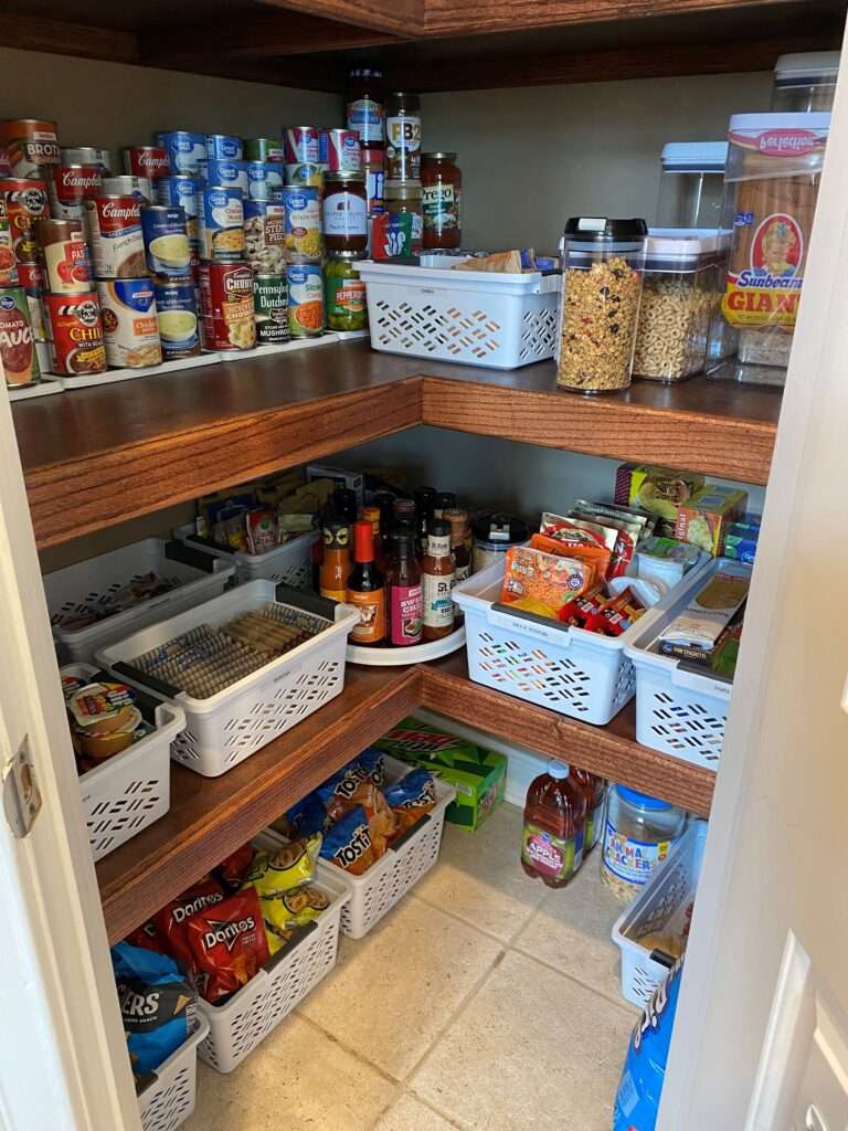 Canned goods on stair step racks, and some plastic bins and lazy susans in the corner pantry.