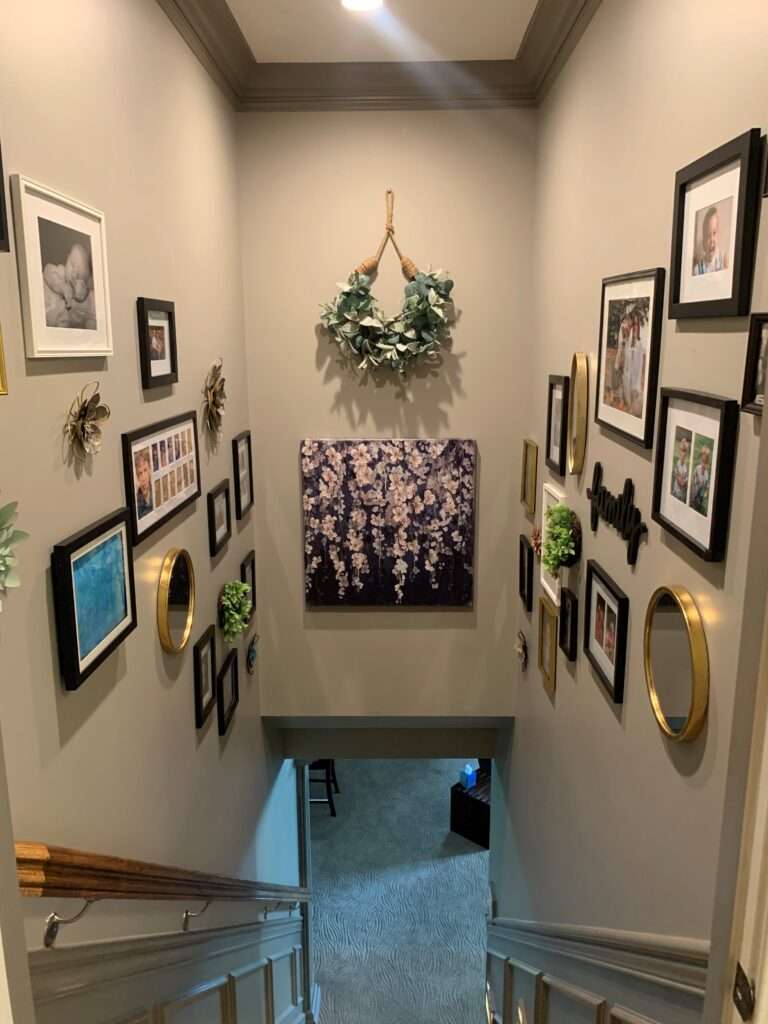 Wall decorations on both sides of a stairwell, looking down the stairs..