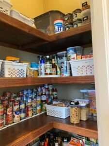 Canned goods on stair step racks, and some plastic bins and lazy susans in the corner pantry.