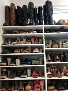 Well organized shoe cubbies with tall boots on the top.