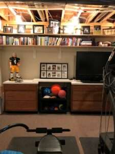 Organized bookshelf and sports memorabilia collection.