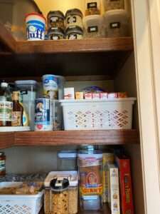 Some plastic bins in the corner pantry.