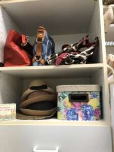Organized purses and hats in the closet.
