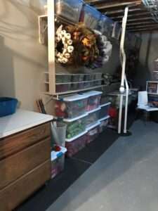 Organized holiday table settings in plastic bins in the basement.