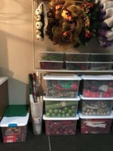 Organized holiday table settings in plastic bins in the basement.