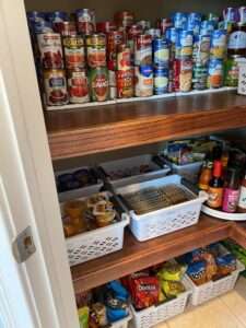 Canned goods on stair step racks, and some plastic bins and lazy susans in the corner pantry.