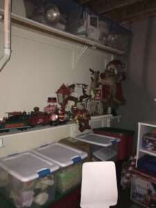 Organized holiday decorations, some in plastic bins in the basement.