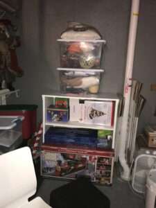 Organized holiday decorations, some in plastic bins in the basement.