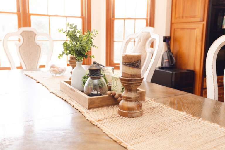 Close up of dining table runner with natural décor.
